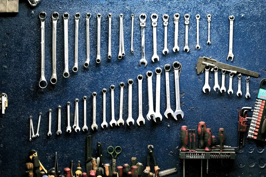Rows of wrenches hanging in order on a workshop wall